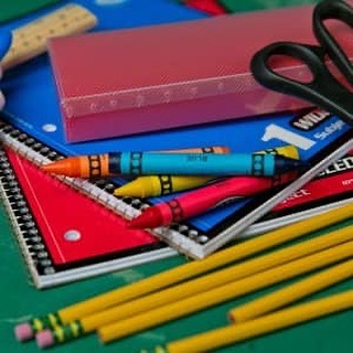 picture of school supplies:  crayons, pencils, notebooks, scissors