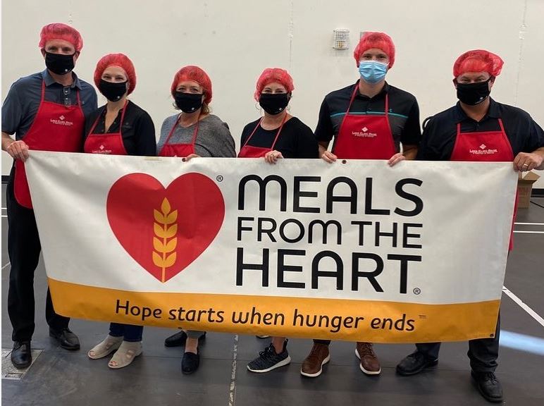 photo of Lake Elmo 
Bank employees holding a Meals From The Heart Sign after voluteering.