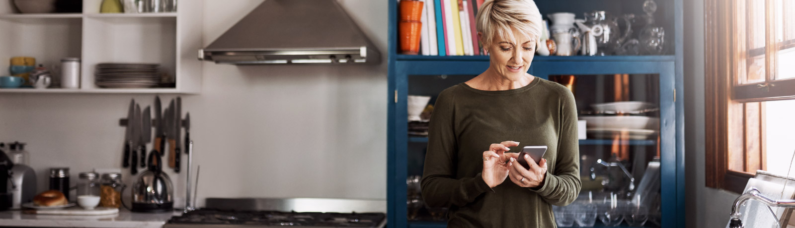 Mature woman on phone in kitchen